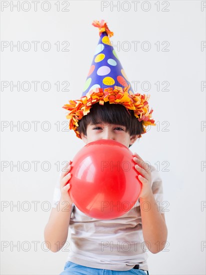 Studio Shot of young boy with ball. Photo : Jessica Peterson