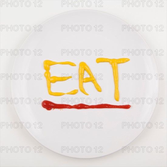 Word EAT written with mustard and ketchup. Photo: Jessica Peterson