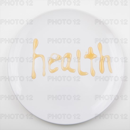 Word HEALTH on white plate. Photo : Jessica Peterson