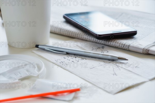 Coffee, smartphone and papers.