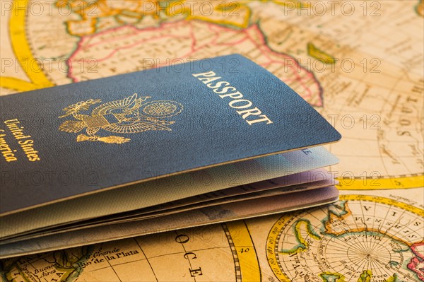 Passport sitting on antique map.