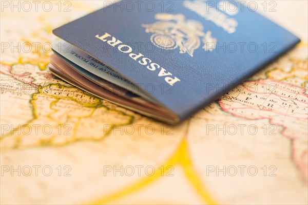 Passport sitting on antique map.