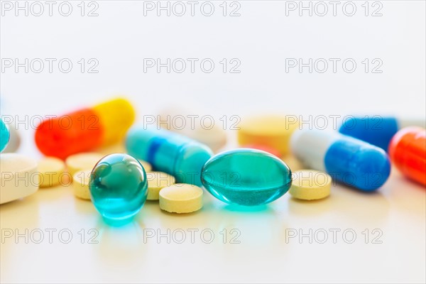 Colorful pills on white background.