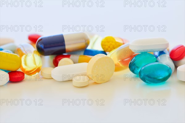 Colorful pills on white background.
