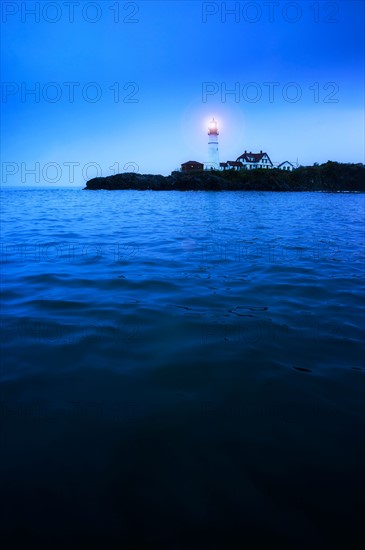 Remote coastline with lighthouse. Portland, Maine.