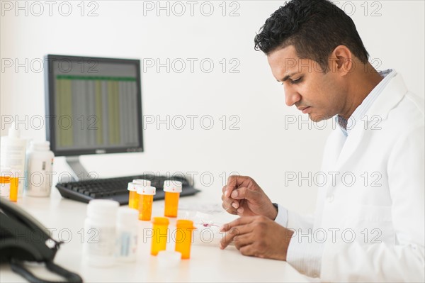 Pharmacist preparing prescription medicine.