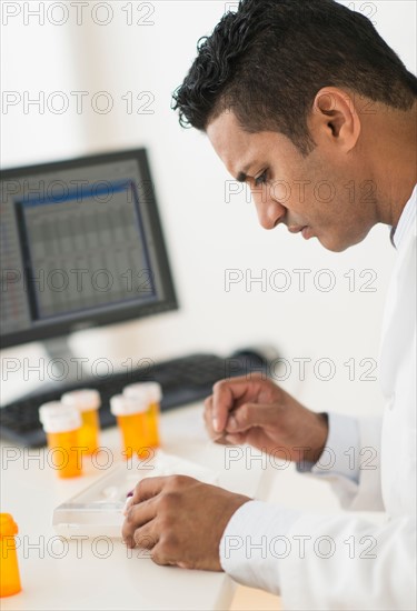 Pharmacist preparing prescription medicine.