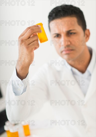 Pharmacist preparing prescription pills.