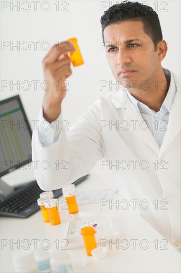 Pharmacist preparing prescription pills.