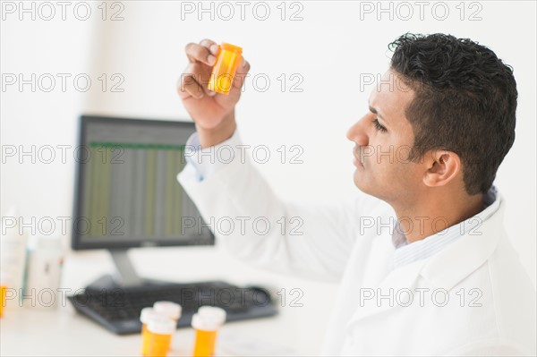 Pharmacist preparing prescription pills.