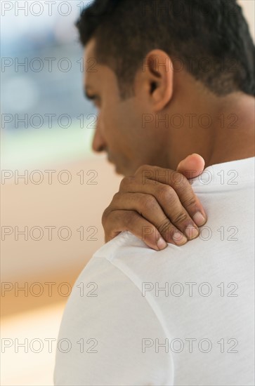 Man massaging his shoulder.
