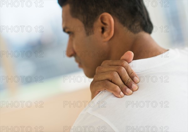 Man massaging his shoulder.