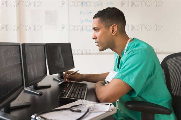 Surgeon working on computer.