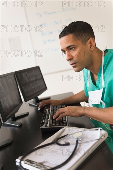 Surgeon working on computer.