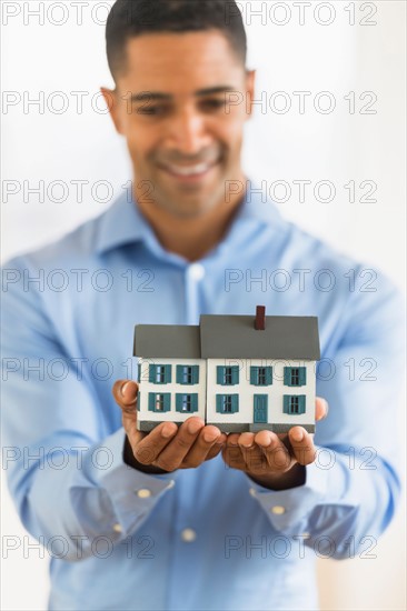 Man holding model home.