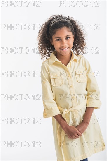 Portrait of smiling girl (6-7), studio shot.