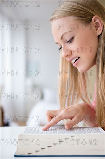 Young woman studying with book
