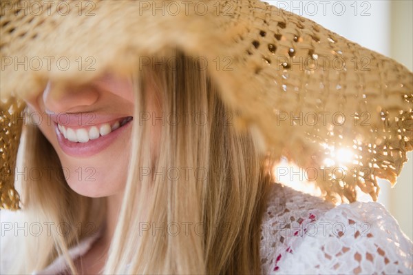 Smiling young woman wearing straw hat