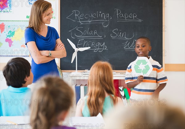 School children (8-9) with female teacher during class