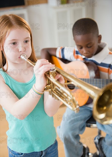 School children (8-9) with playing instruments during music class