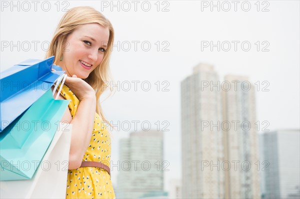Portrait of young woman with shopping bags