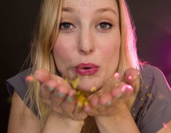 Portrait of young woman blowing kiss