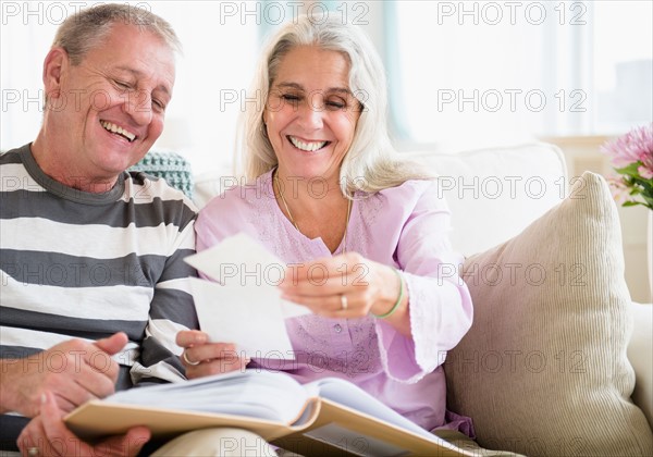 Portrait of elderly couple watching photos