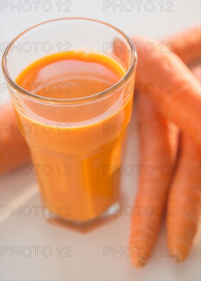 Studio shot of carrots and carrot juice