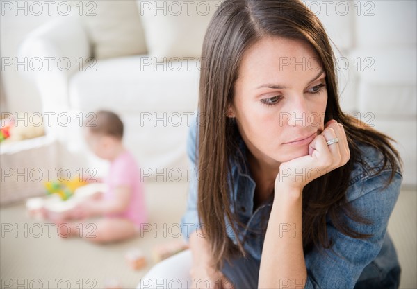 Mother with daughter (6-11 months) in living room