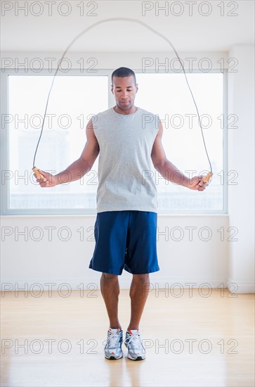 Young man skipping rope