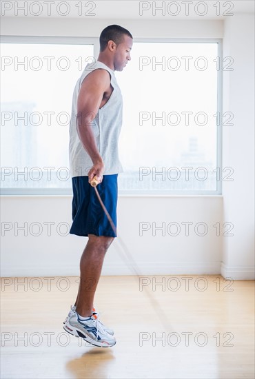Young man skipping rope
