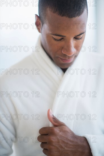 Portrait of young man in white bathrobe