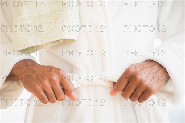 Young man wearing white bathrobe