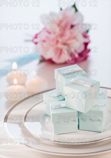 Pastel composition with gifts packages, candles and flowers