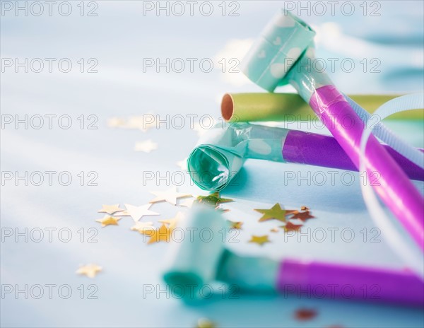 Studio shot of party blowers and confetti