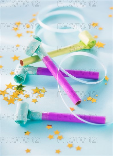 Studio shot of party blowers and confetti