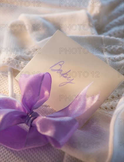 Close-up of envelope and purple bow