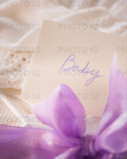 Close-up of envelope and purple bow