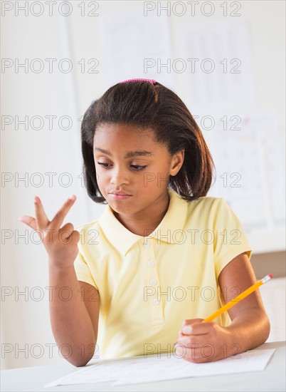 Girl (6-7) doing homework