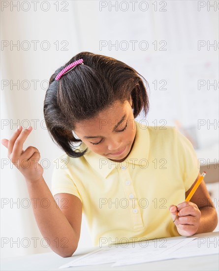 Girl (6-7) doing homework