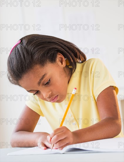 Girl (6-7) doing homework