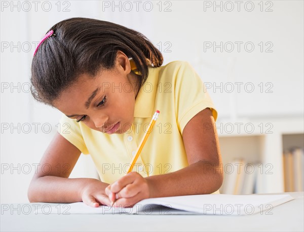 Girl (6-7) doing homework