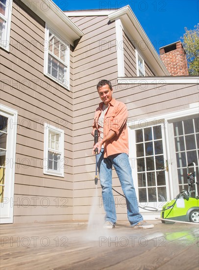 Portrait of man cleaning porch