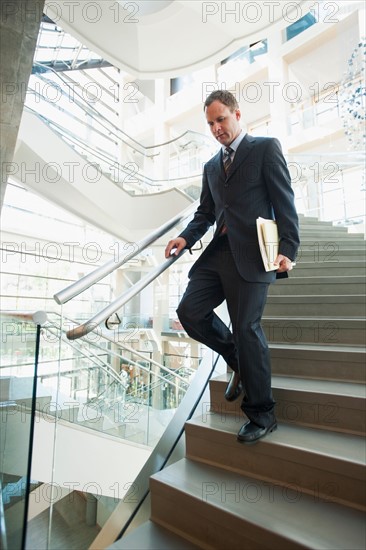 Man walking down stairs in office