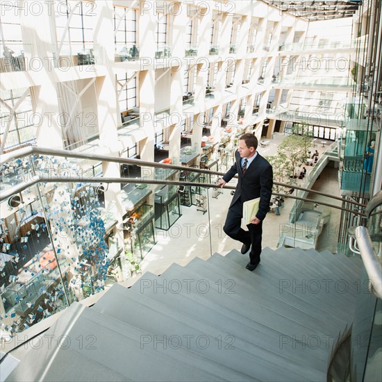 Man walking up stairs in office