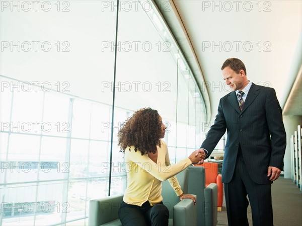 Man and woman greeting in lobby