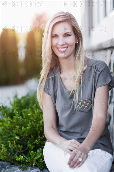 Portrait of smiling woman sitting outdoors