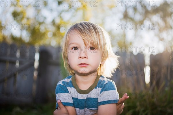 Toddler boy with arms crossed