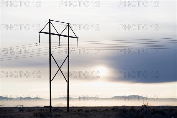 Power lines and tower at sunset