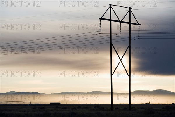 Power lines and tower at sunset